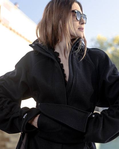 Woman wearing a black coat with a blurred background
